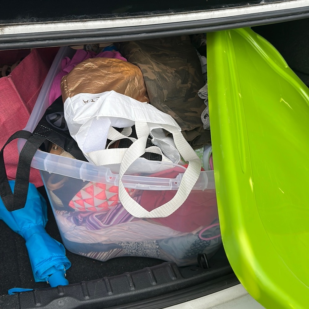 Tub of clothes and shoes.